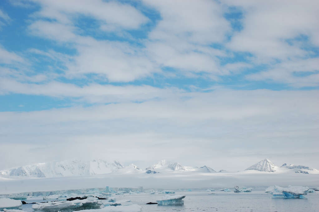 A wide landscape with mostly very bright white ice and snow.