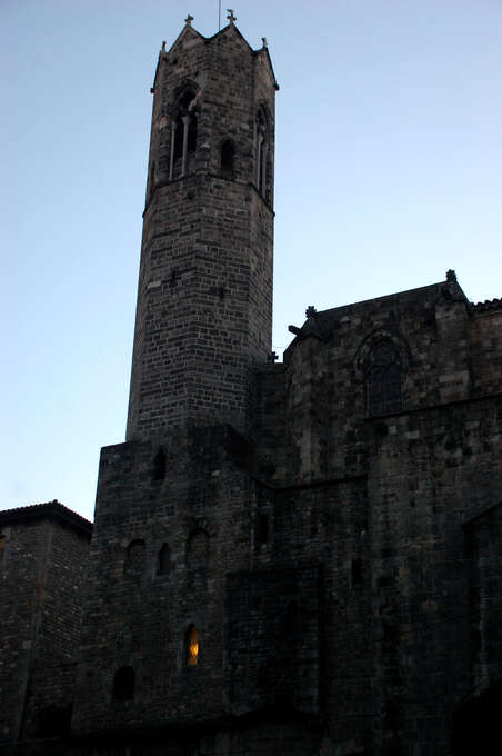 A brick castle with a light in one window.