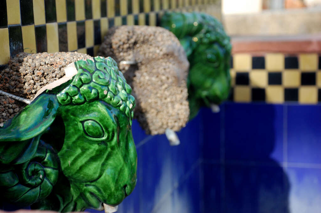 Three fountains in the shape of sheep heads.