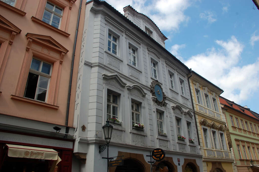 Differently colored storefronts along a street.