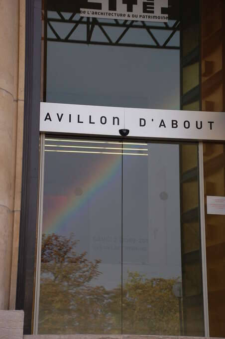 A reflection of a rainbow in a glass door.