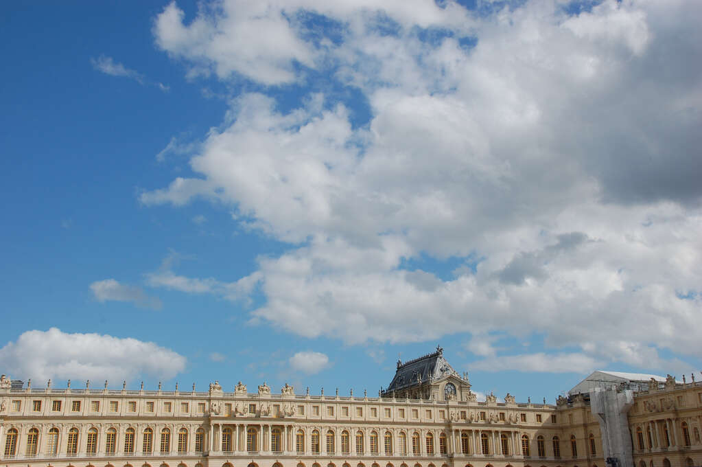 The front of Versaille in the bottom of the frame with sky filling the top.