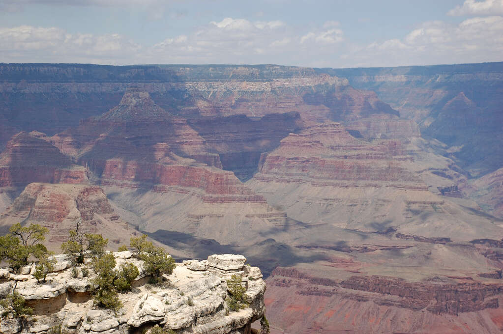 The canyon wall in the background with a rocky outcropping in the foreground.